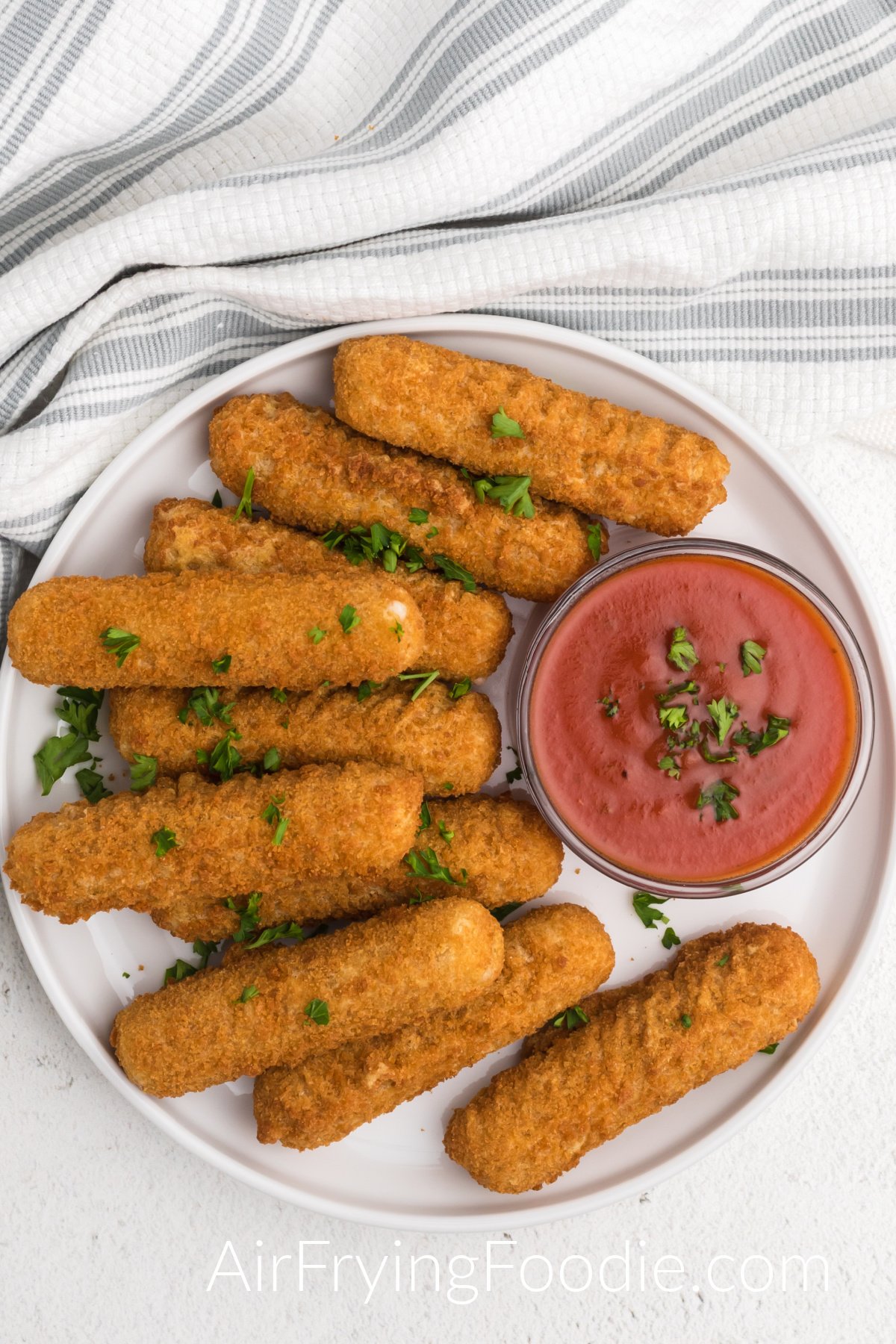 plate full of mozzarella sticks made from frozen in the air fryer 