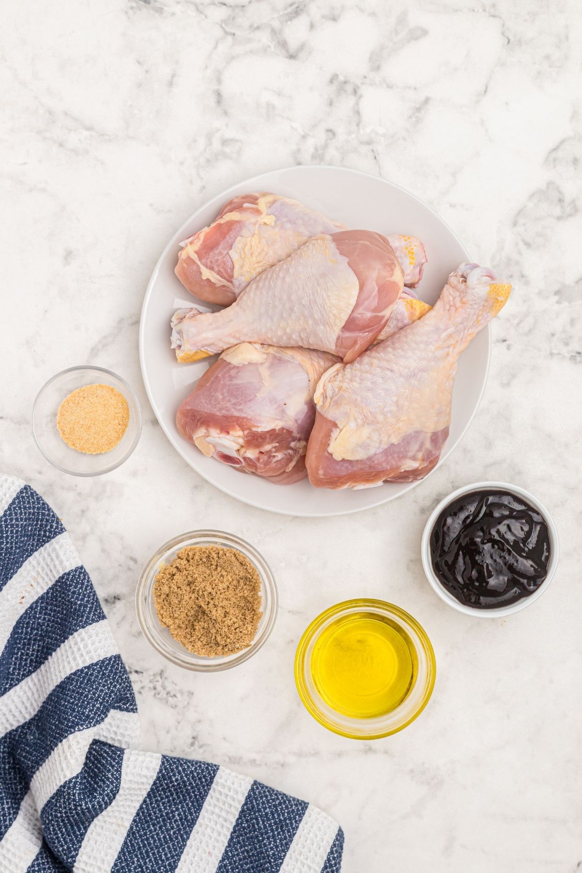 Ingredients to make air fryer barbecue chicken laid out on a counter before cooking.