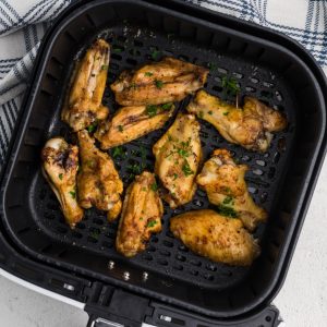 Seasoned wings that were cooked from frozen in the air fryer basket.