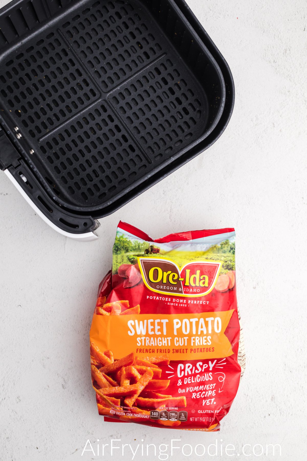 Ore Ida Frozen Sweet Potato Fries in a bag ready to be placed into the air fryer basket. 