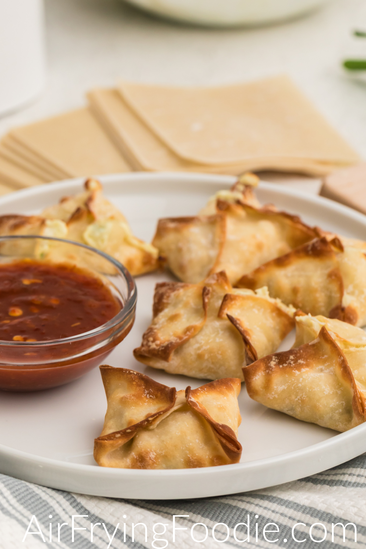 Air fried crab rangoon on a white plate and ready to serve. 