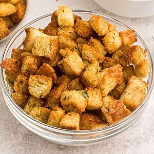 Golden crispy croutons stacked in a bowl.