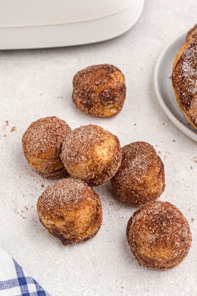 Golden donut holes glazed with cinnamon and sugar coating