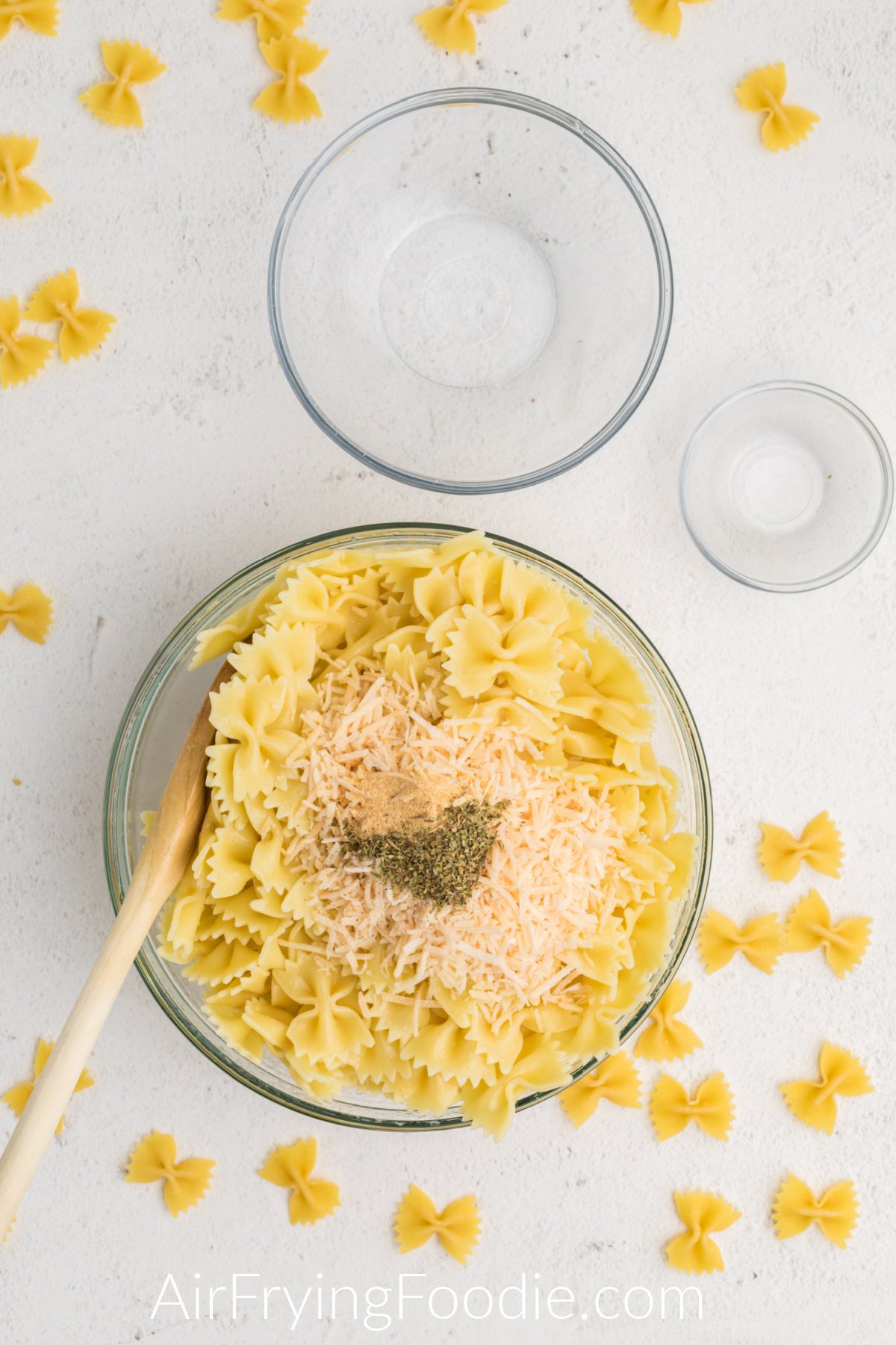 Cooked pasta with cheese and seasonings added.