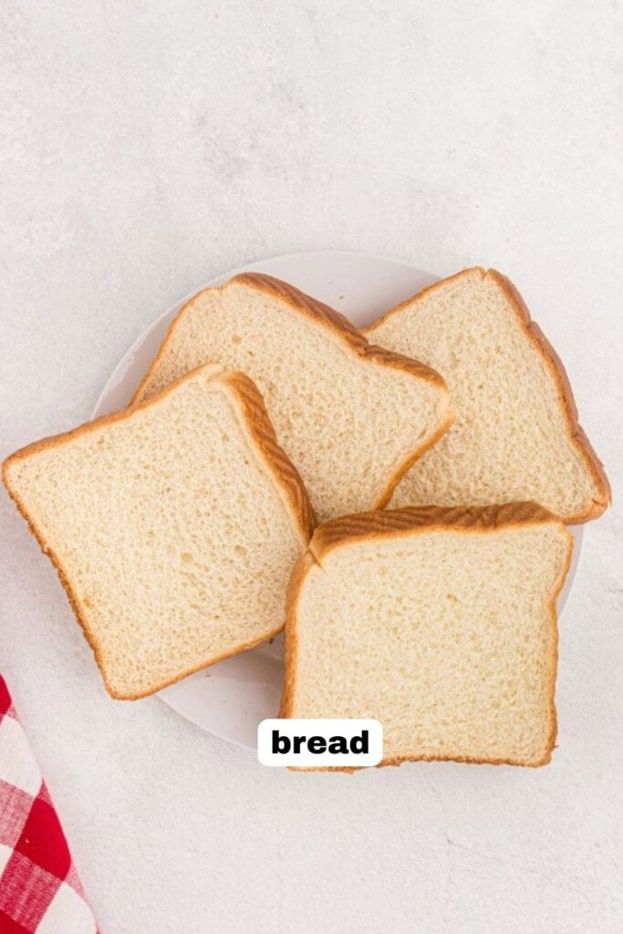 Plate of white bread slices on a white table before being toasted in the air fryer. 