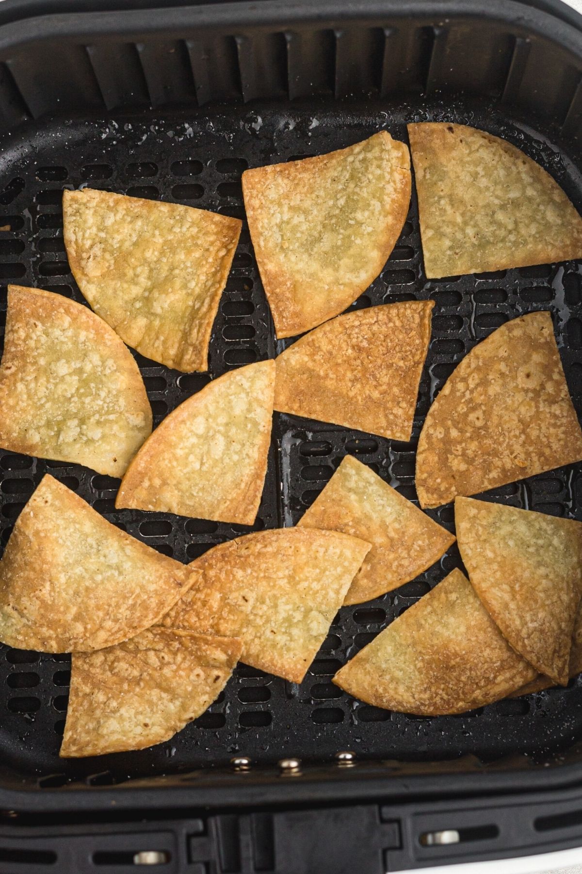 tortilla chips in air fryer basket.