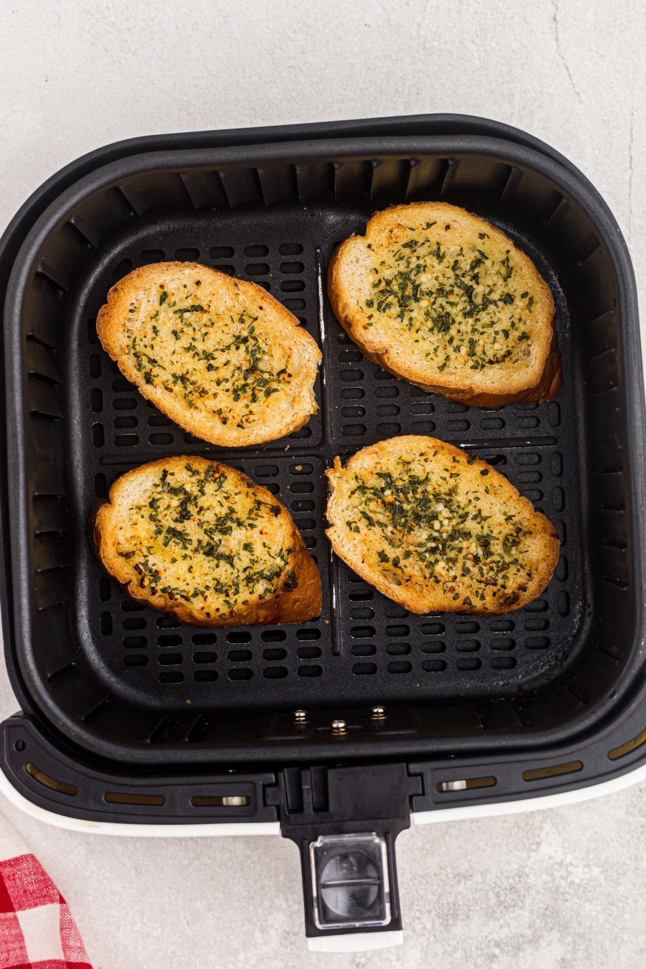 Golden toasted garlic bread slices in the air fryer basket