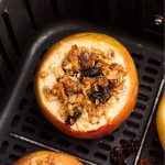 Golden baked apples filled with oats, raisins, nuts mixture after being cooked in the air fryer
