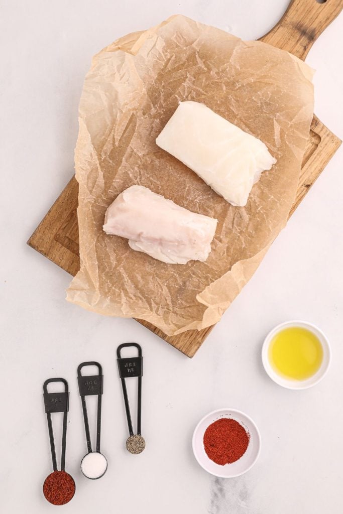 Ingredients measured out to make halibut with seasonings in measuring spoons