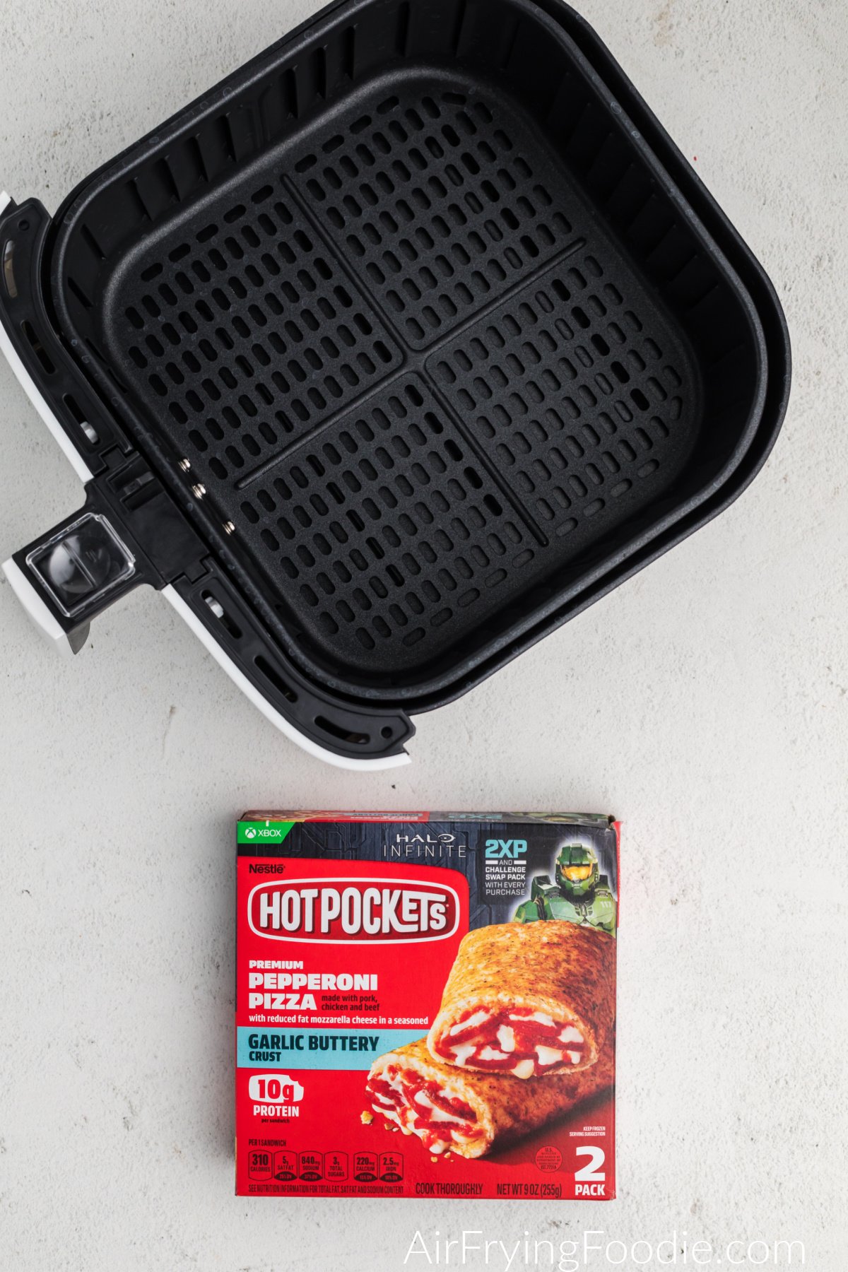 Air Fryer basket and box of frozen hot pockets. 