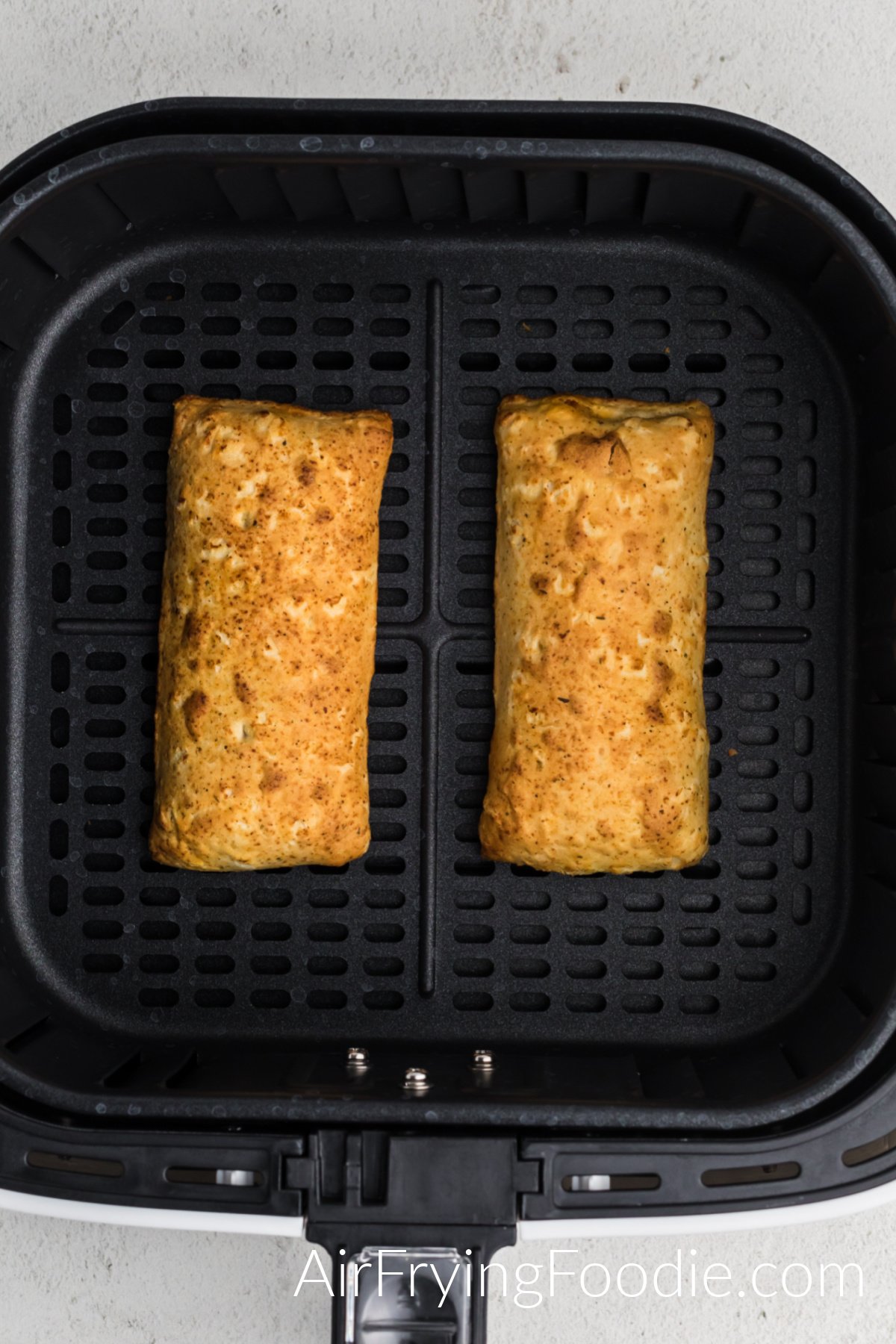 Fully cooked hot pockets in air fryer basket. 