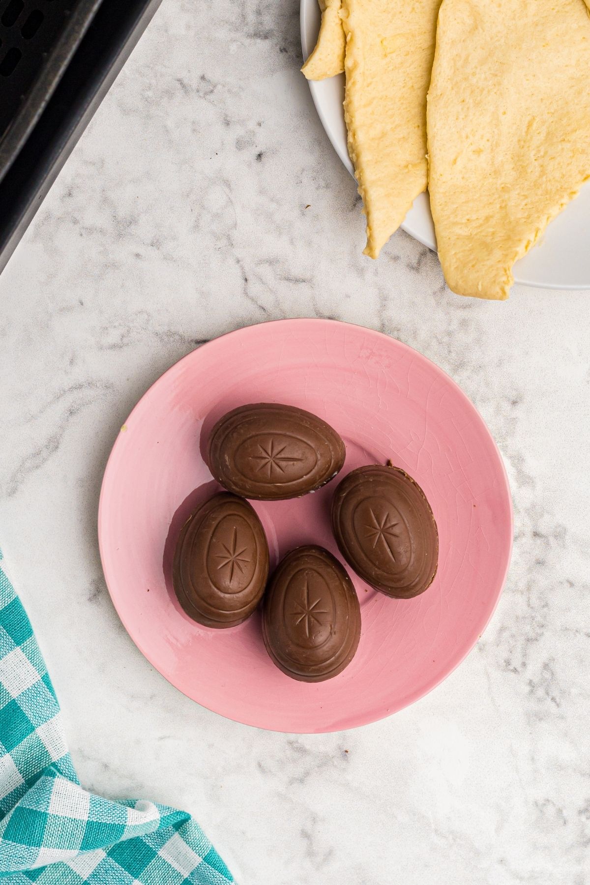 Unwrapped chocolate eggs and lay out crescent rolls