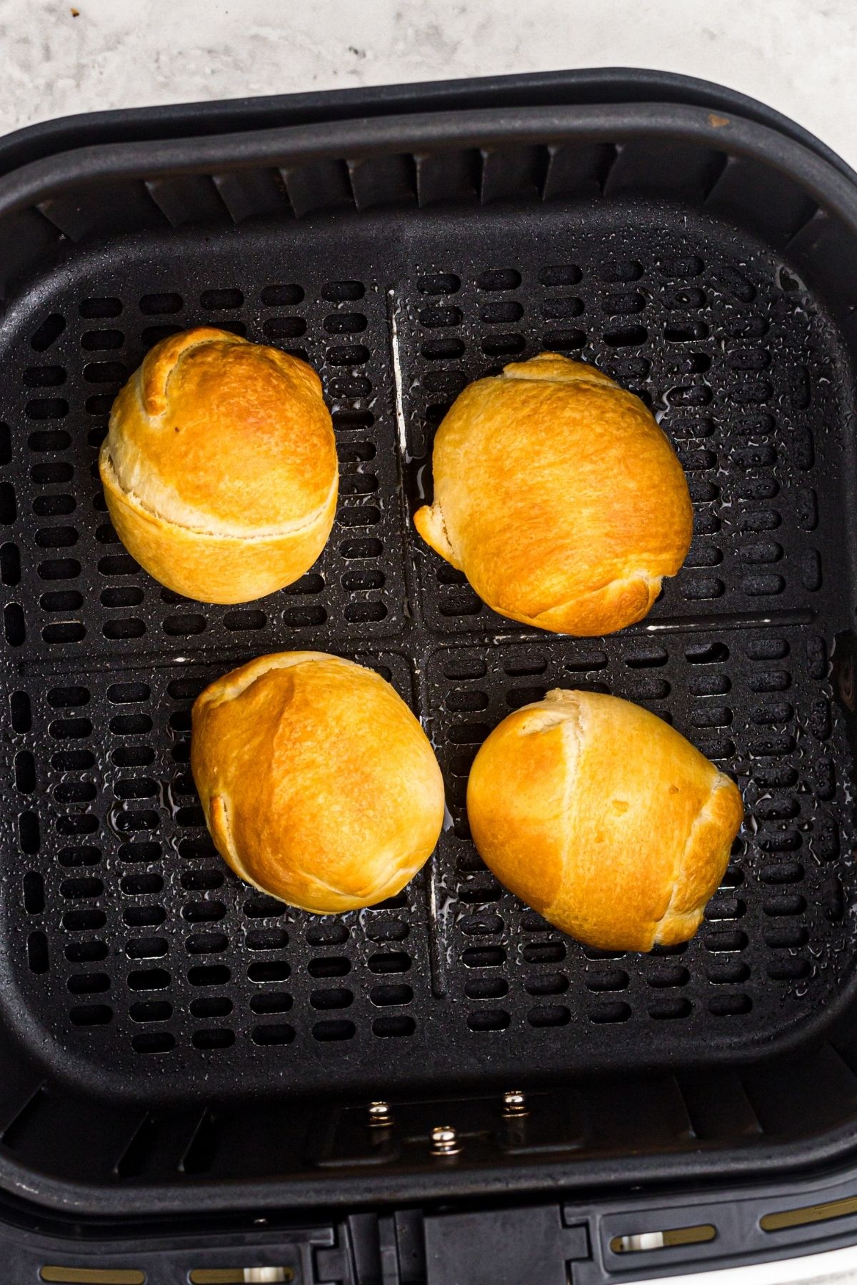 Golden wrapped chocolate eggs in the air fryer basket