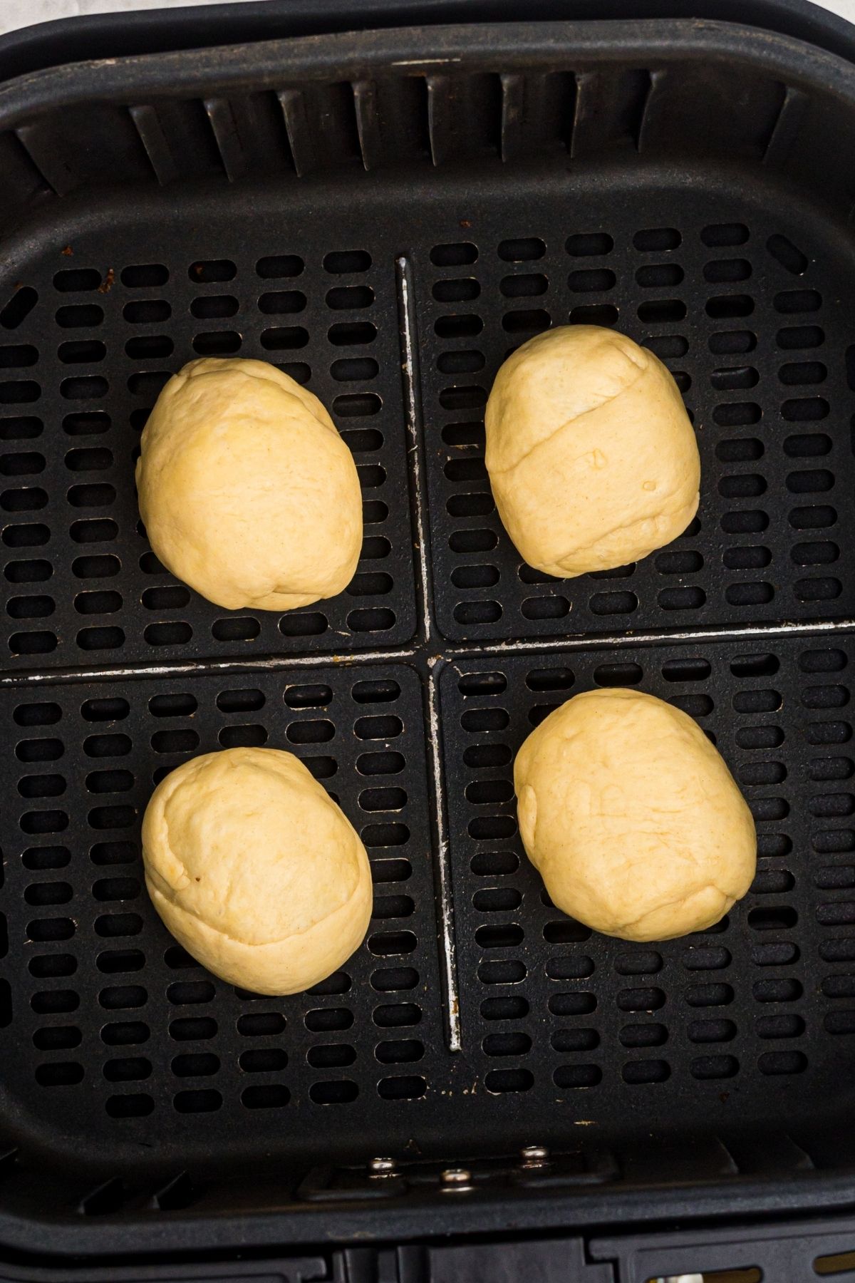 Crescent wrapped cadbury eggs in the air fryer basket before being cooked
