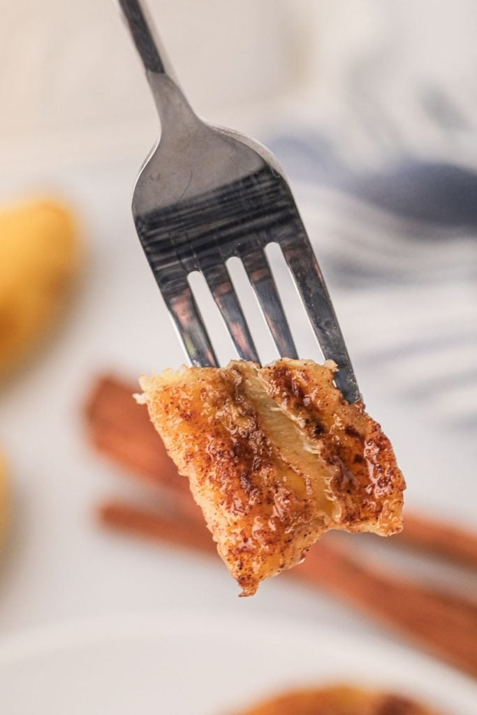 Fork bite shot of air fried banana seasoned with sugar and butter
