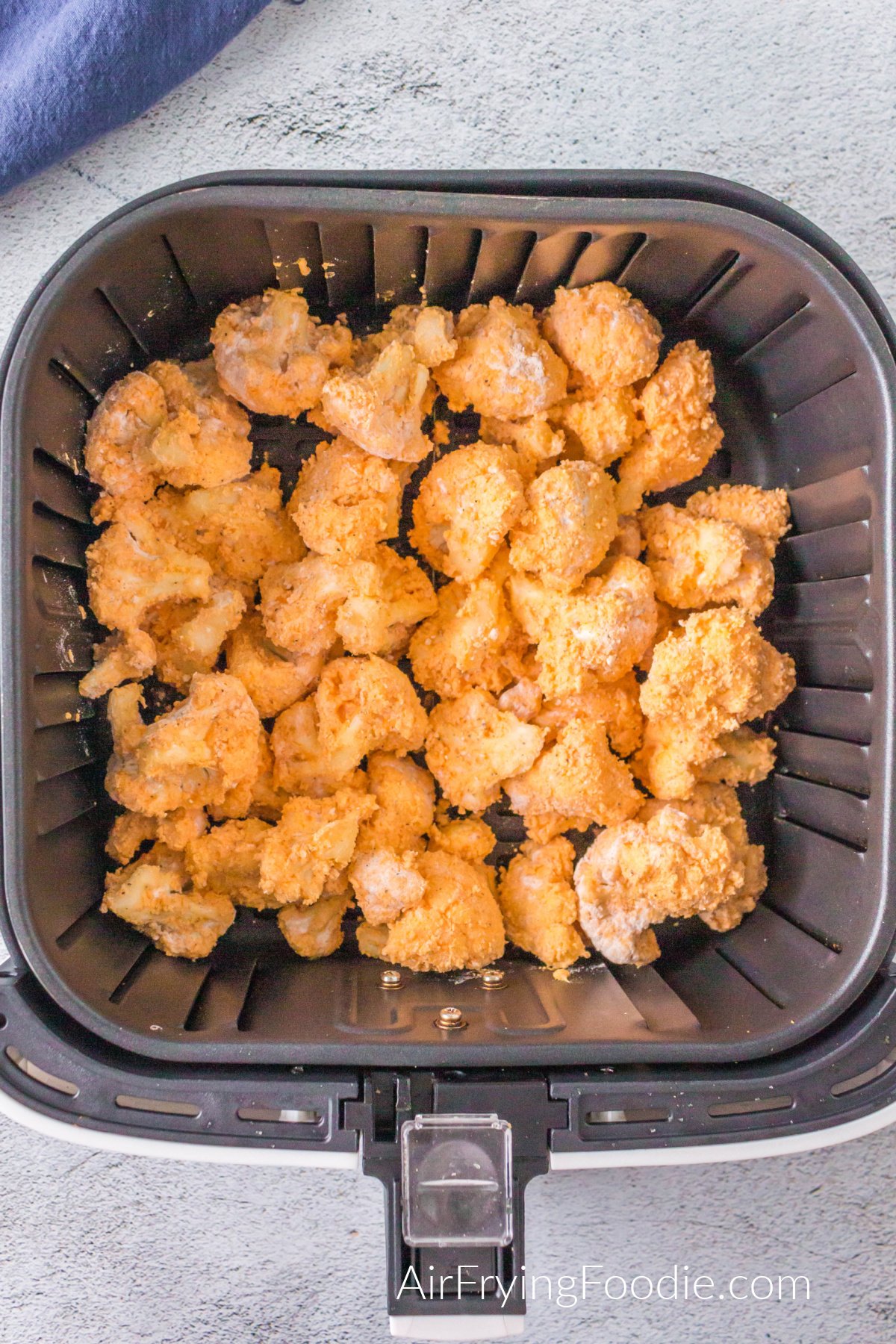Buffalo Cauliflower in the air fryer ready to cook.