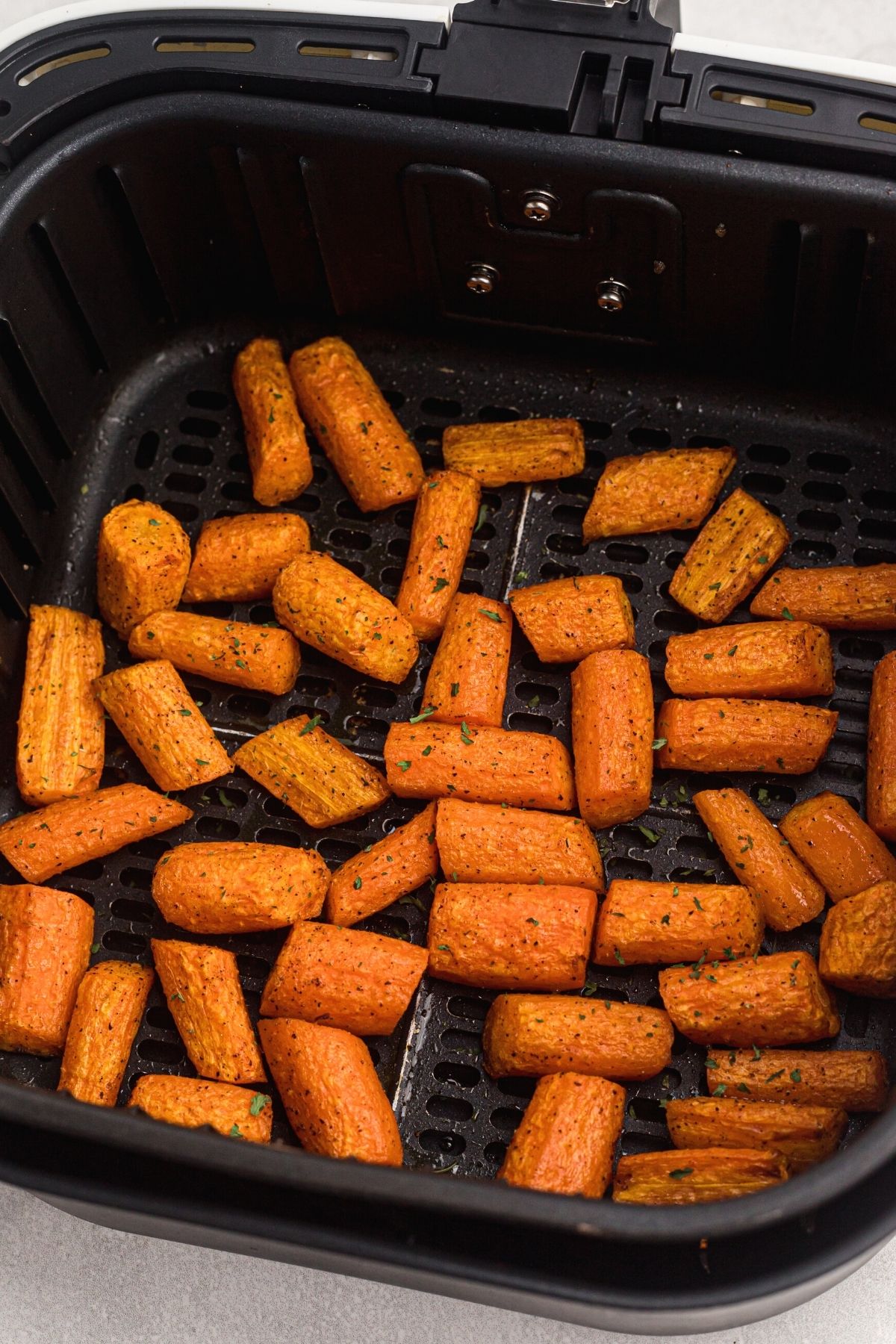 Seasoned carrots cooked in the air fryer basket.