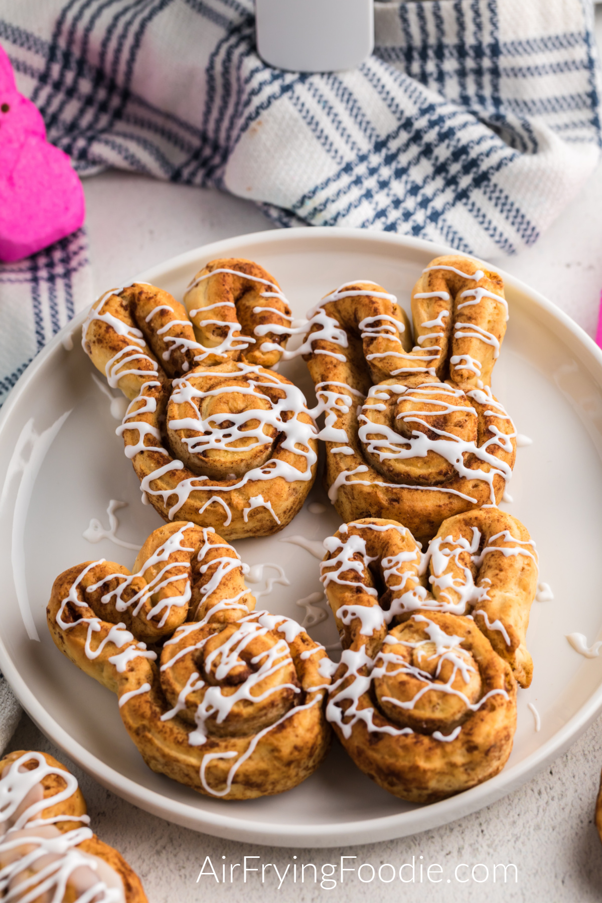 Air Fryer Cinnamon Roll Bunnies on a white plate and ready to serve.