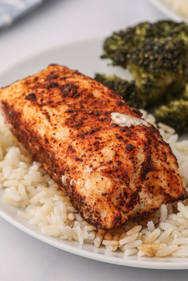 Seasoned cooked filet on a bed of rice after being cooked in the air fryer