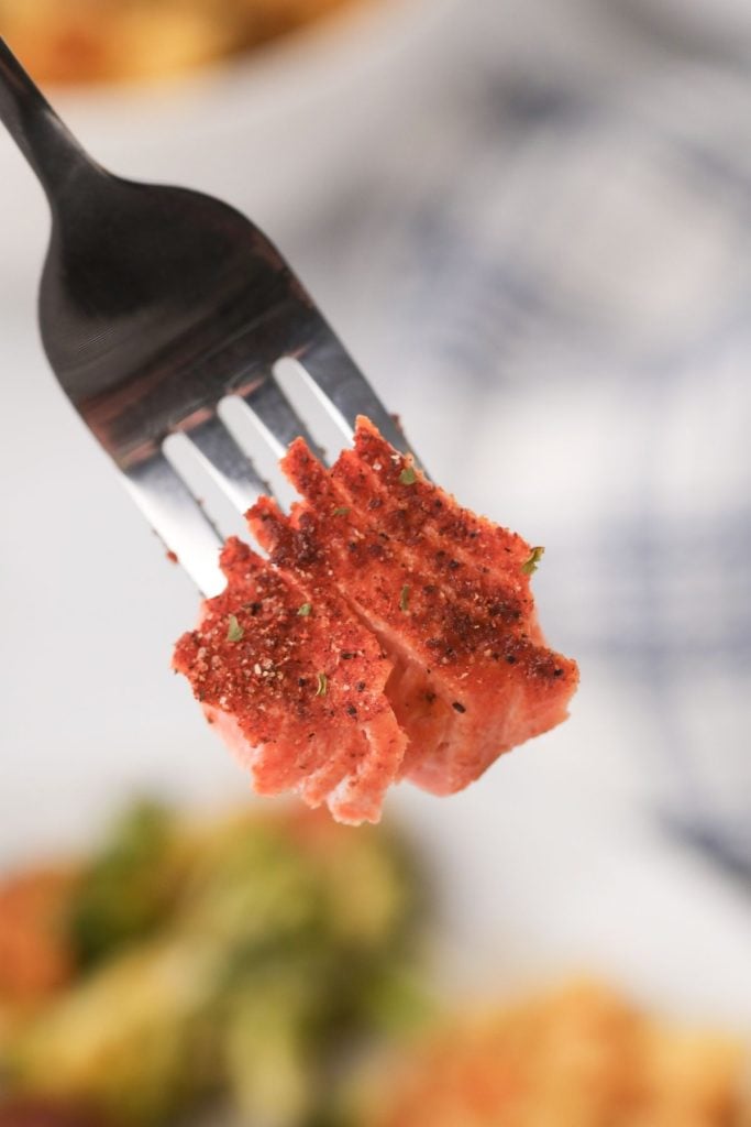 Fork bite of flaky seasoned salmon 