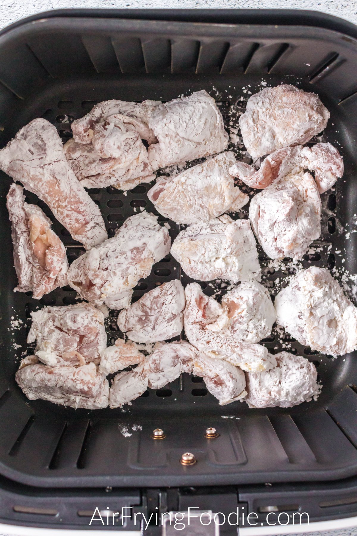Coated chicken in the basket of the air fryer