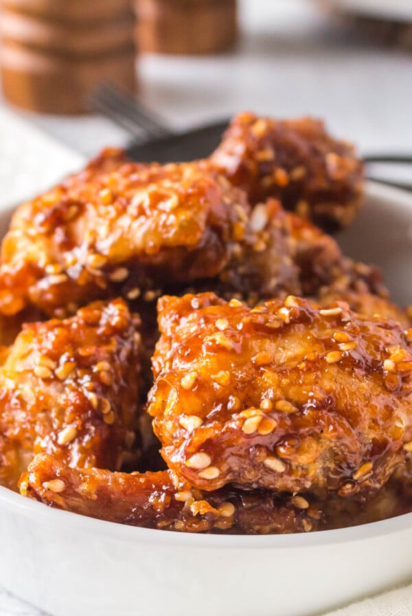 Air fried sesame chicken in a white bowl and ready to serve.