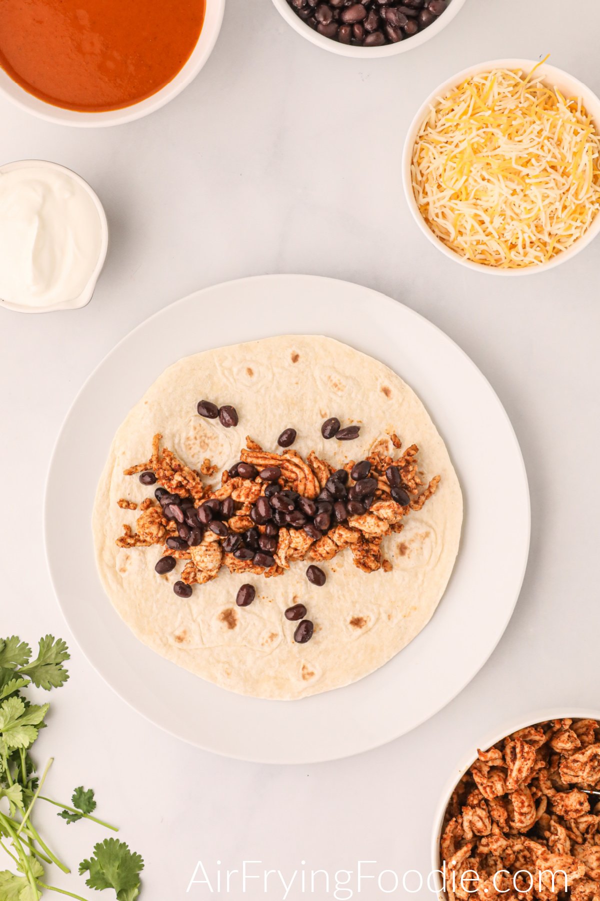 Tortilla topped with chicken and black beans.