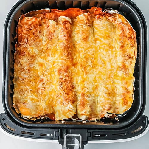 Air fryer enchiladas in the basket, ready to serve.