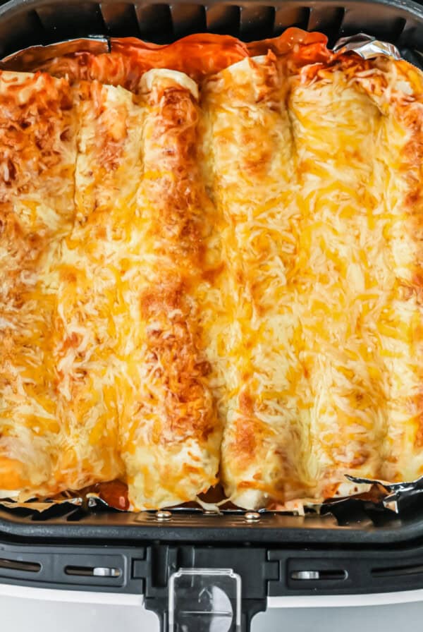 Air fryer enchiladas in the basket, ready to serve.