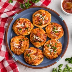 Overhead photo of air fryer mini pizzas on a blue plate.