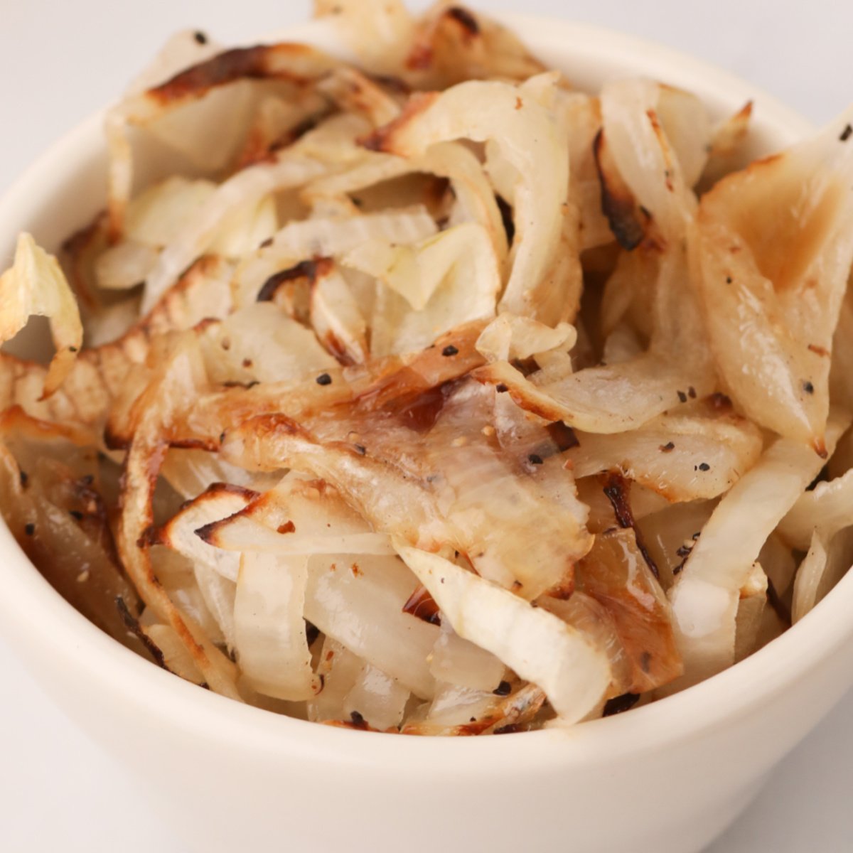 Bowl of sauteed fried onions that were made in the air fryer.