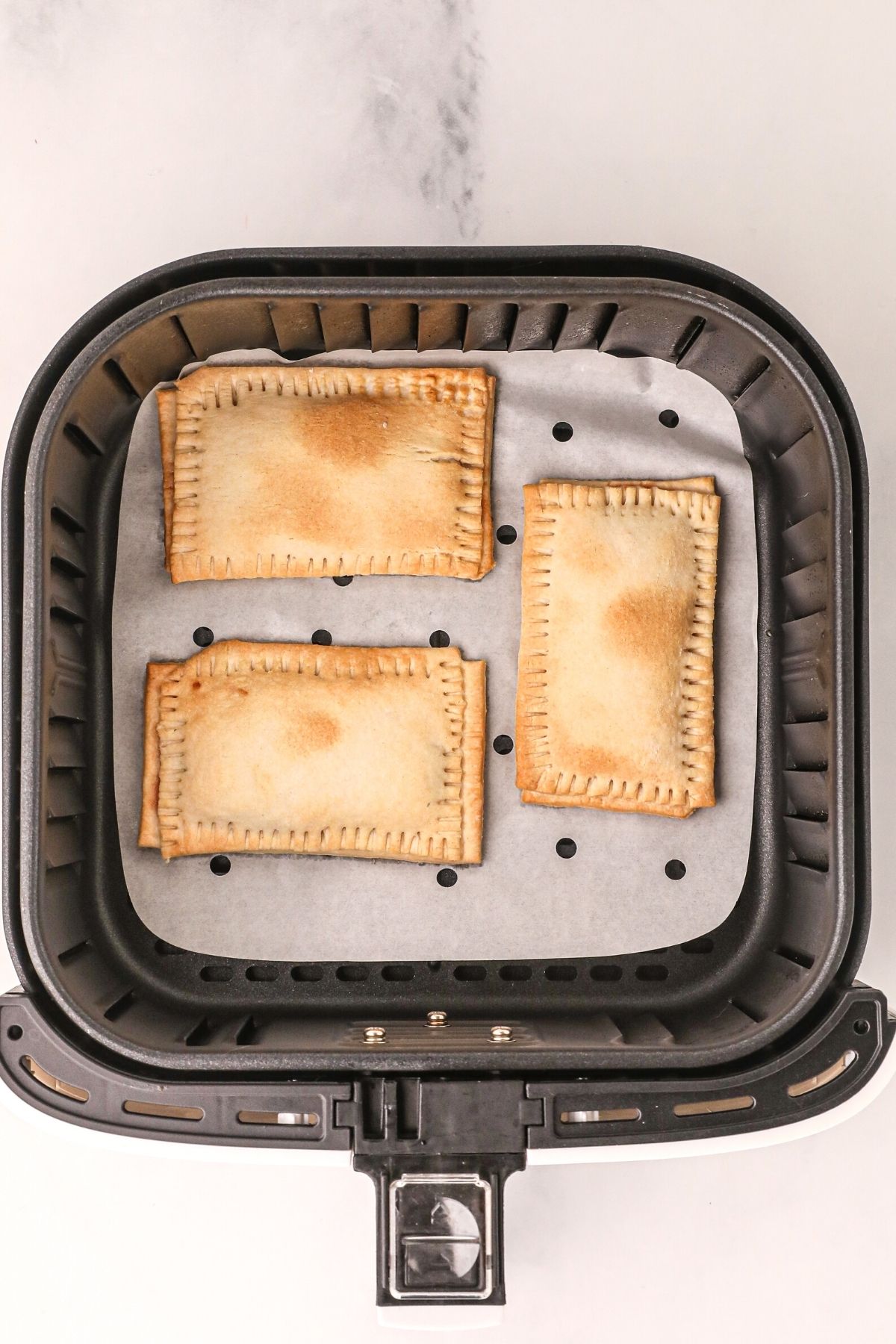 Golden pastries cooked in the air fryer basket