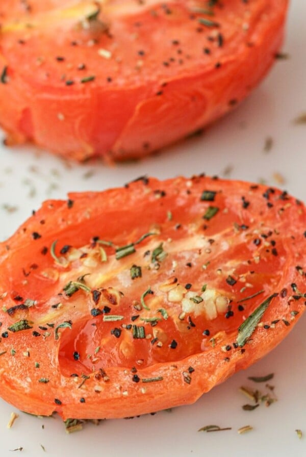 seasoned and sliced air fried tomato on a white board