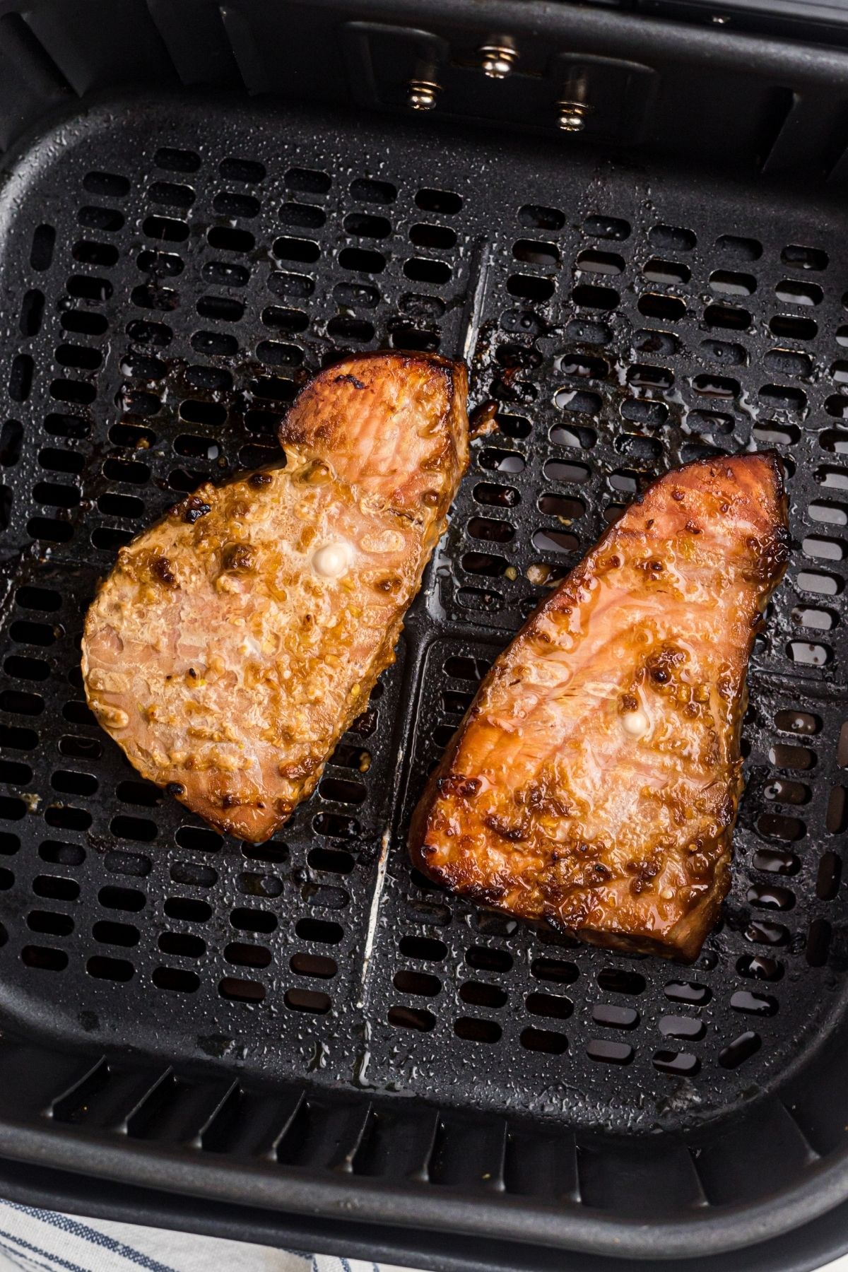 Juicy golden brown cooked tuna steaks in the air fryer basket