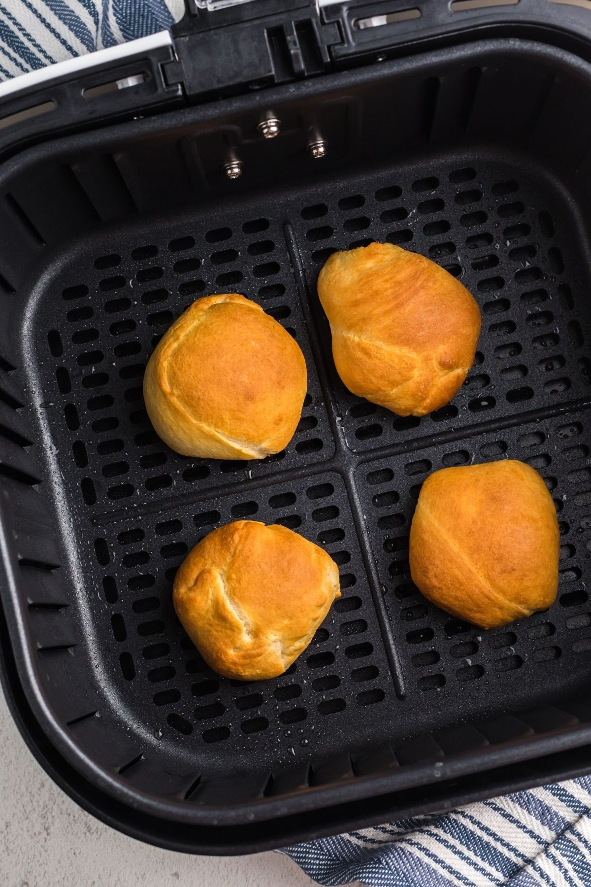 Golden dough with peanut butter cups wrapped inside and cooked in the air fryer basket