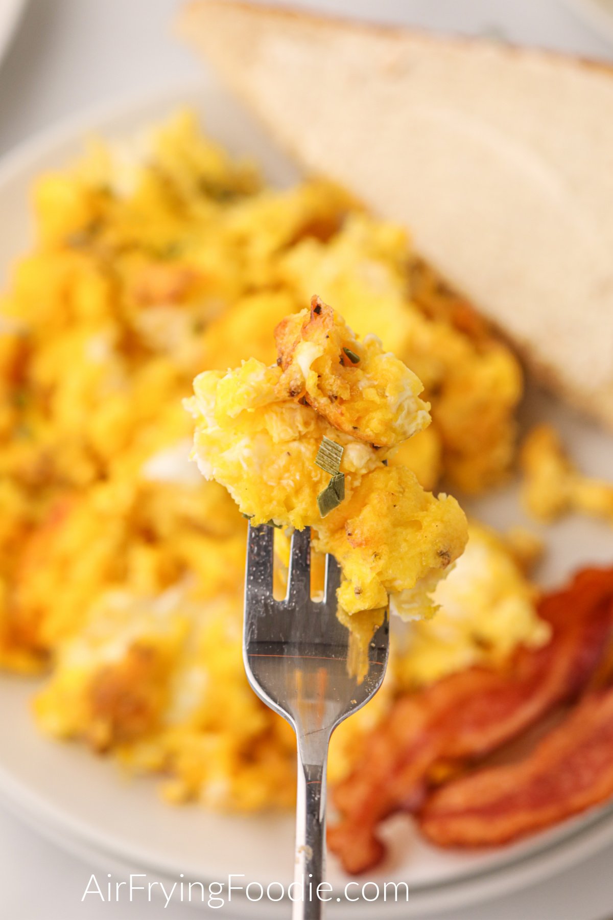 Scrambled eggs on a fork ready to eat. 