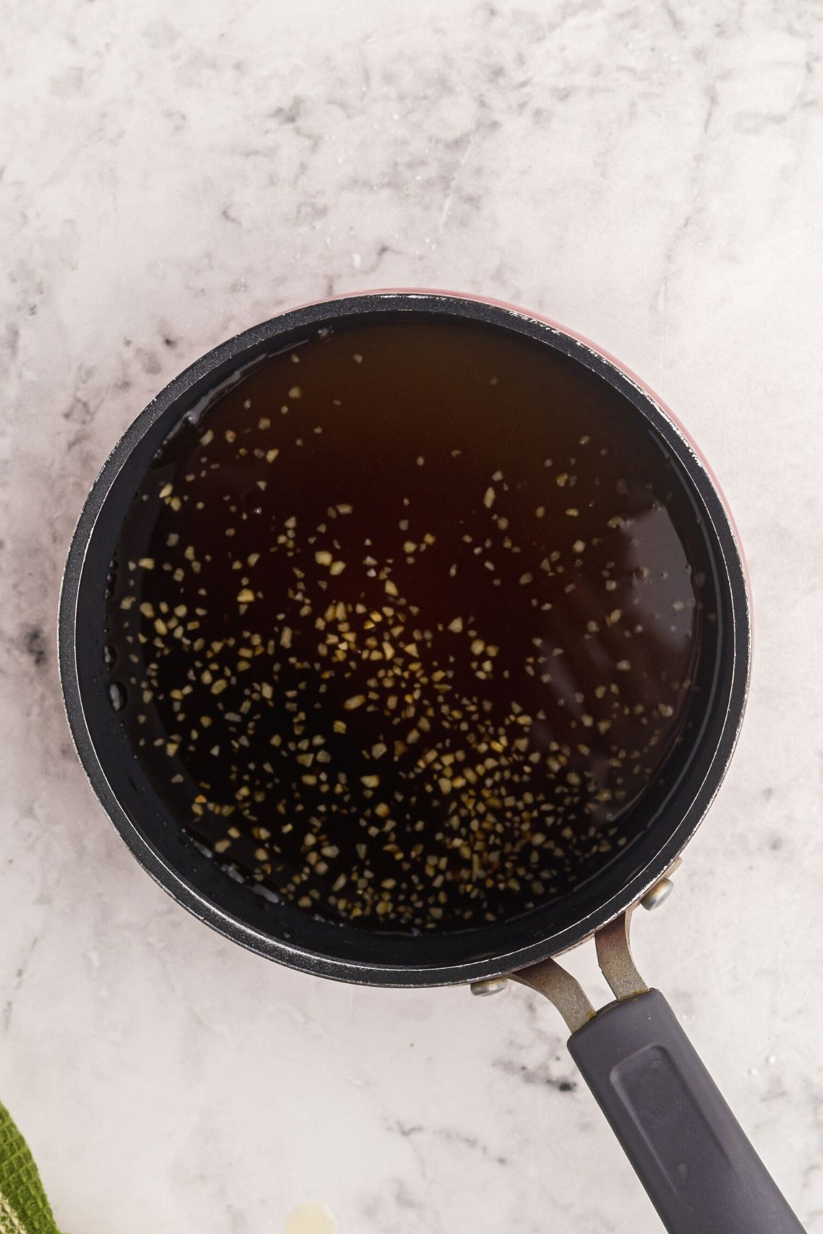 Sweet and sour sauce being made in a small saucepan