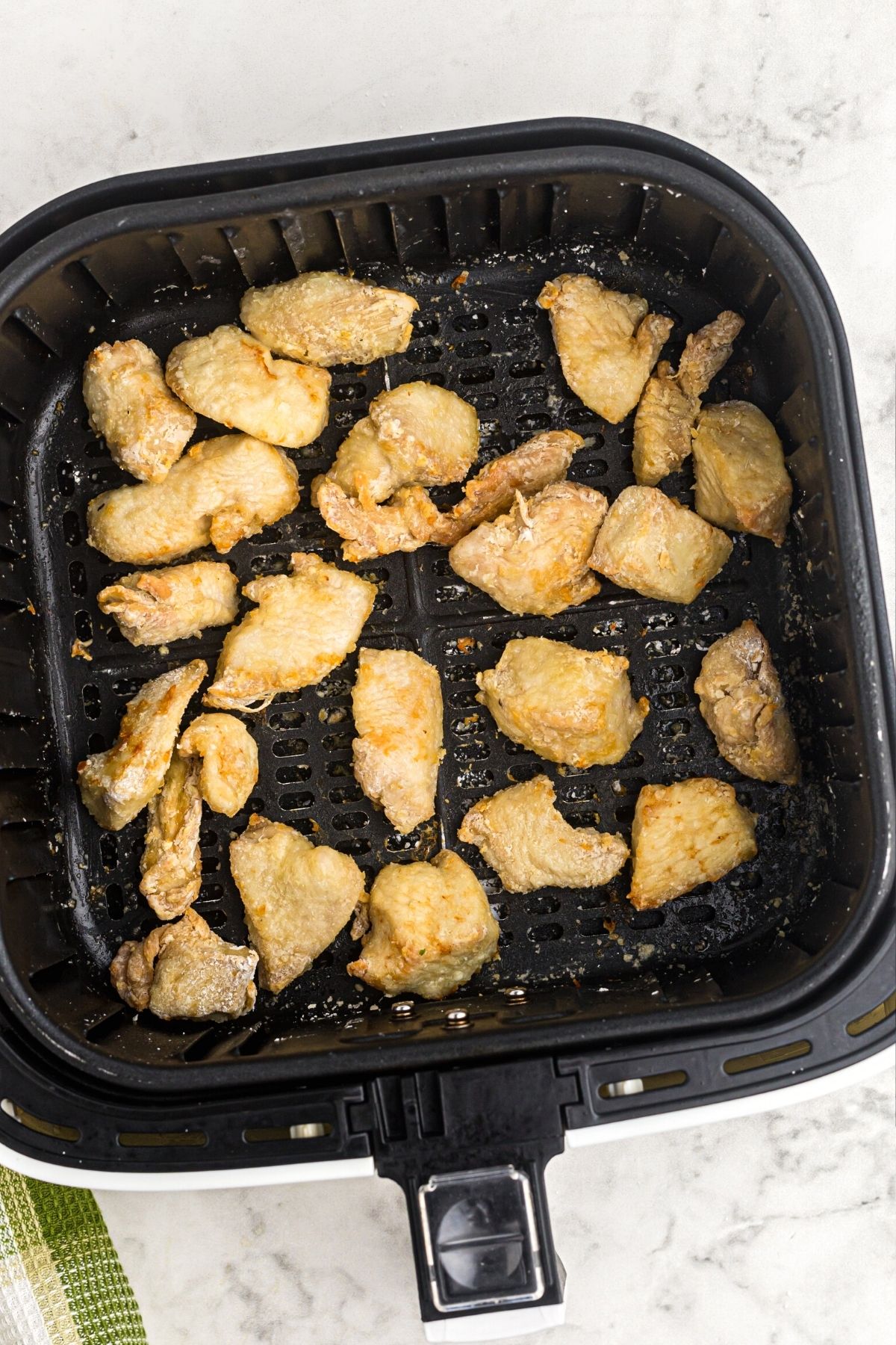 crispy golden chicken pieces cooked in the air fryer basket