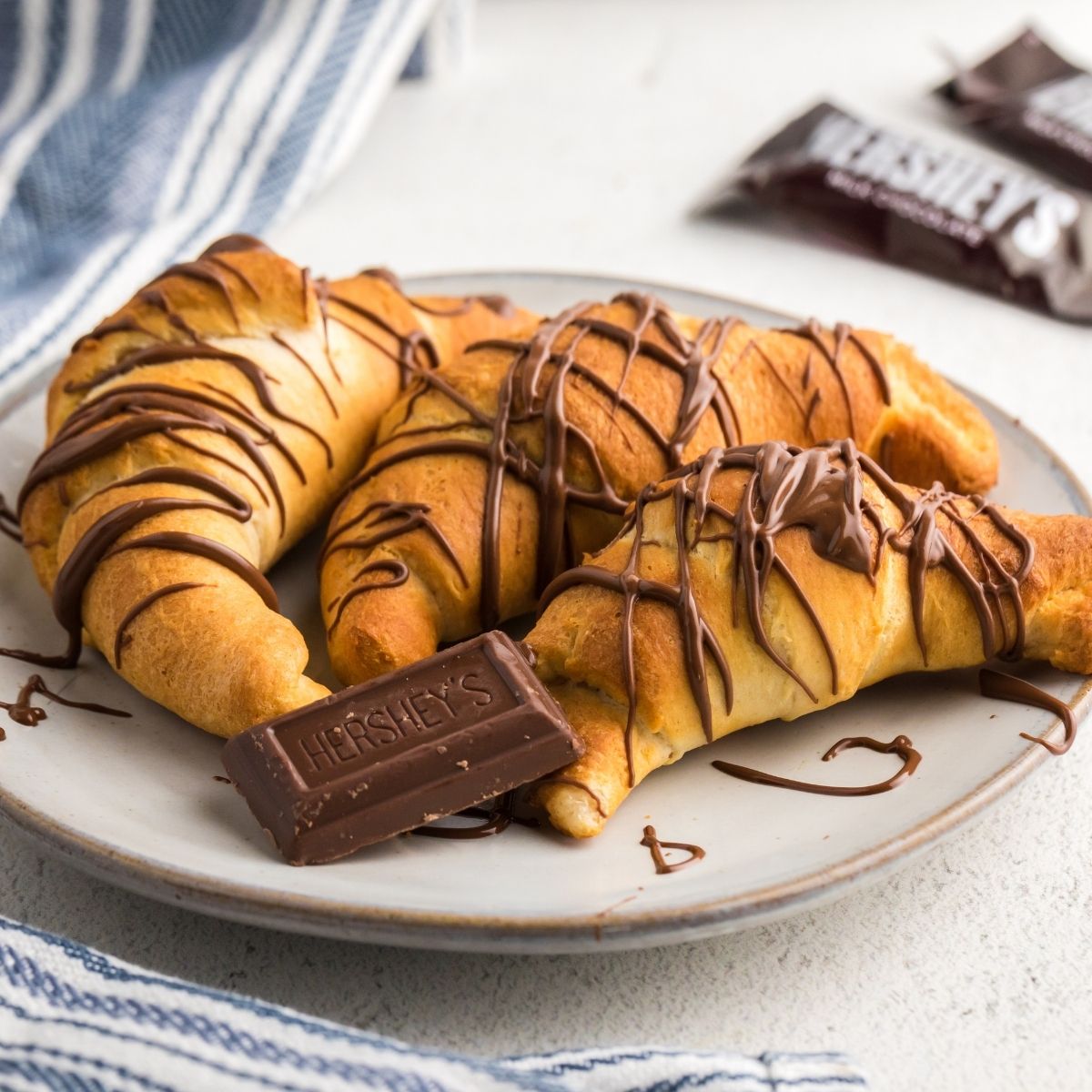 Golden chocolate drizzled crescent rolls in the shape of croissants
