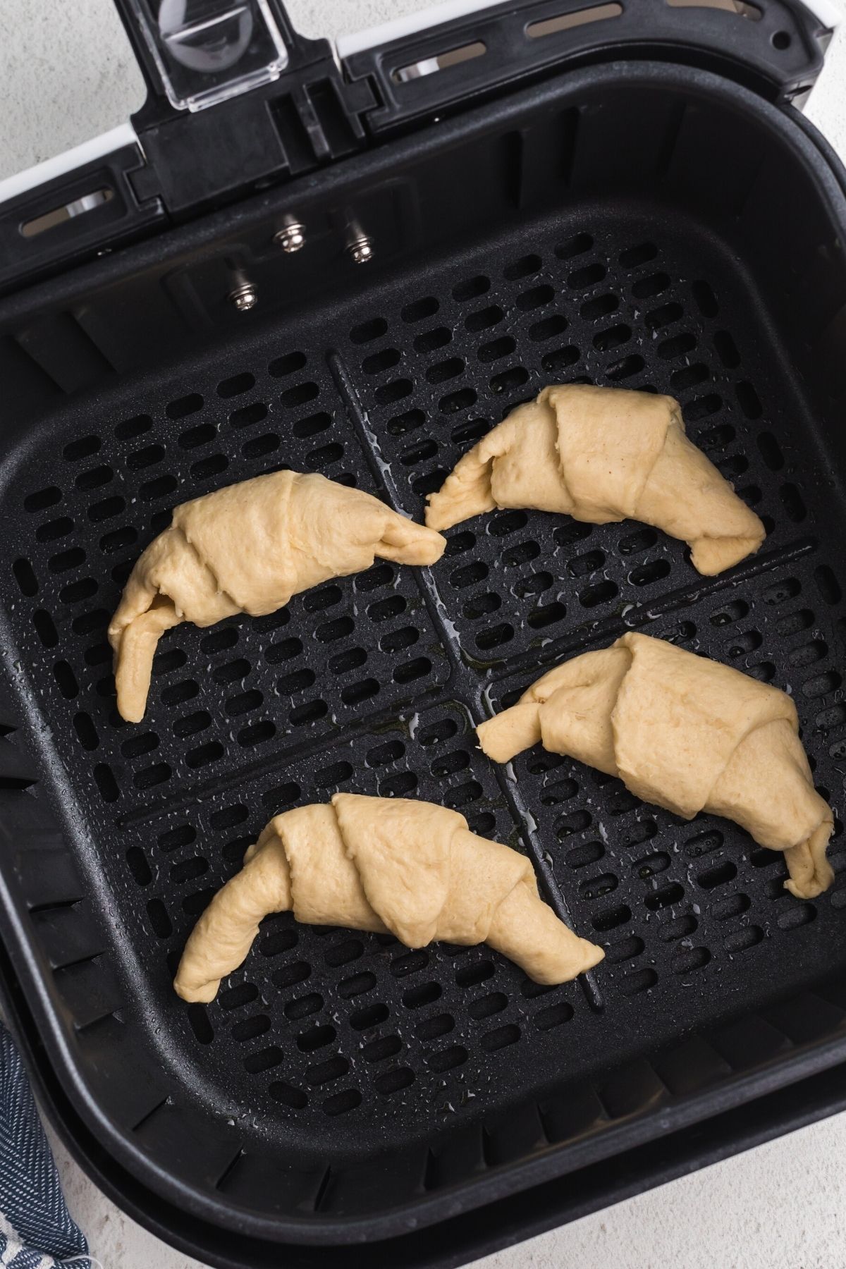 Crescent rolls filled with chocolate placed in the air fryer basket