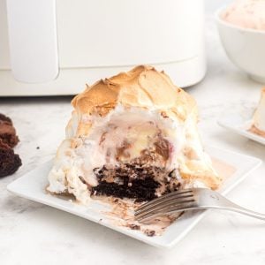 Golden meringue coating over ice cream on a brownie in front of an air fryer