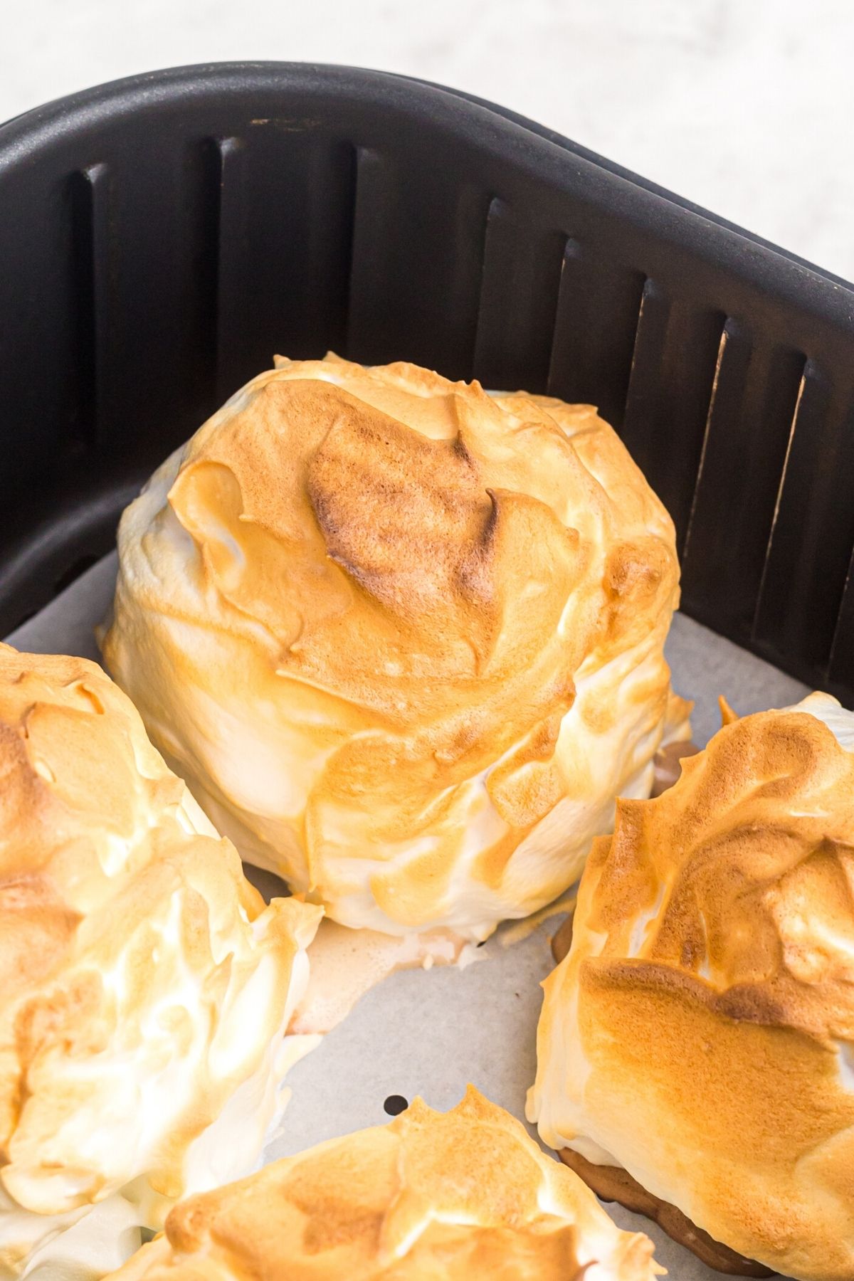 Golden crispy meringue covered brownies in the air fryer basket