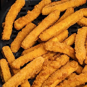 Cooked chicken fries in air fryer basket.