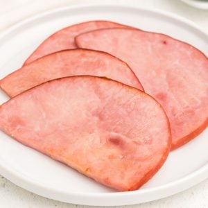 Air fryer ham steaks on a white plate and ready to serve.