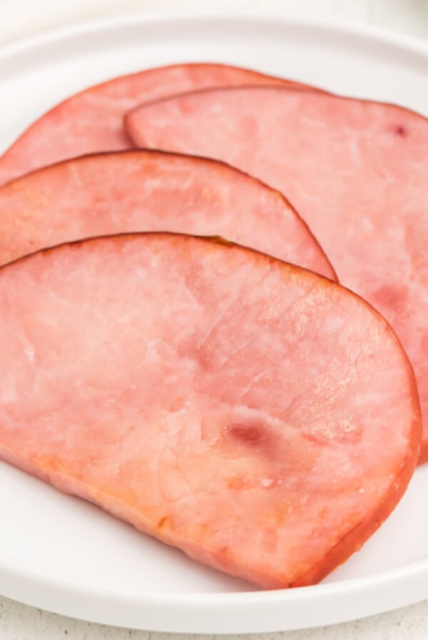 Air fryer ham steaks on a white plate and ready to serve.