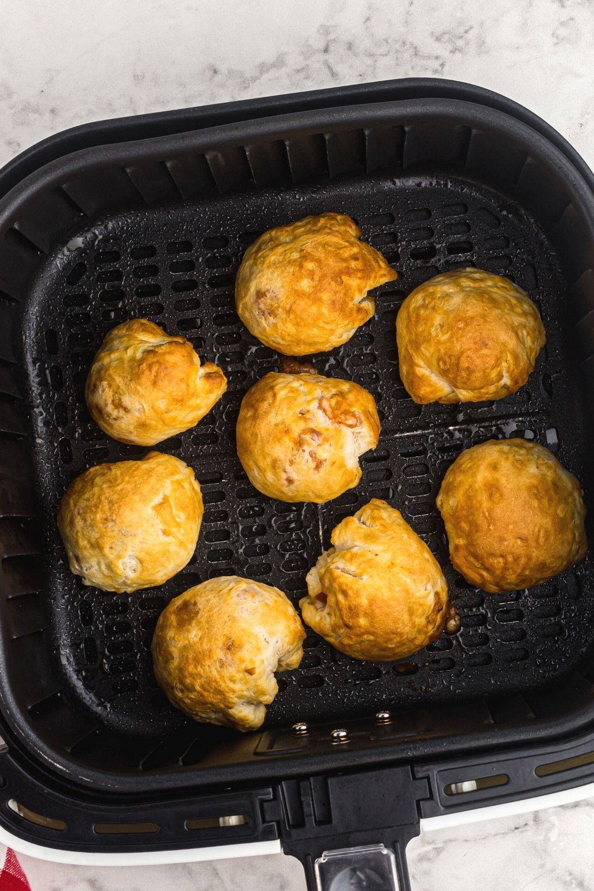 Golden biscuits filled with pizza toppings and cooked in the air fryer basket