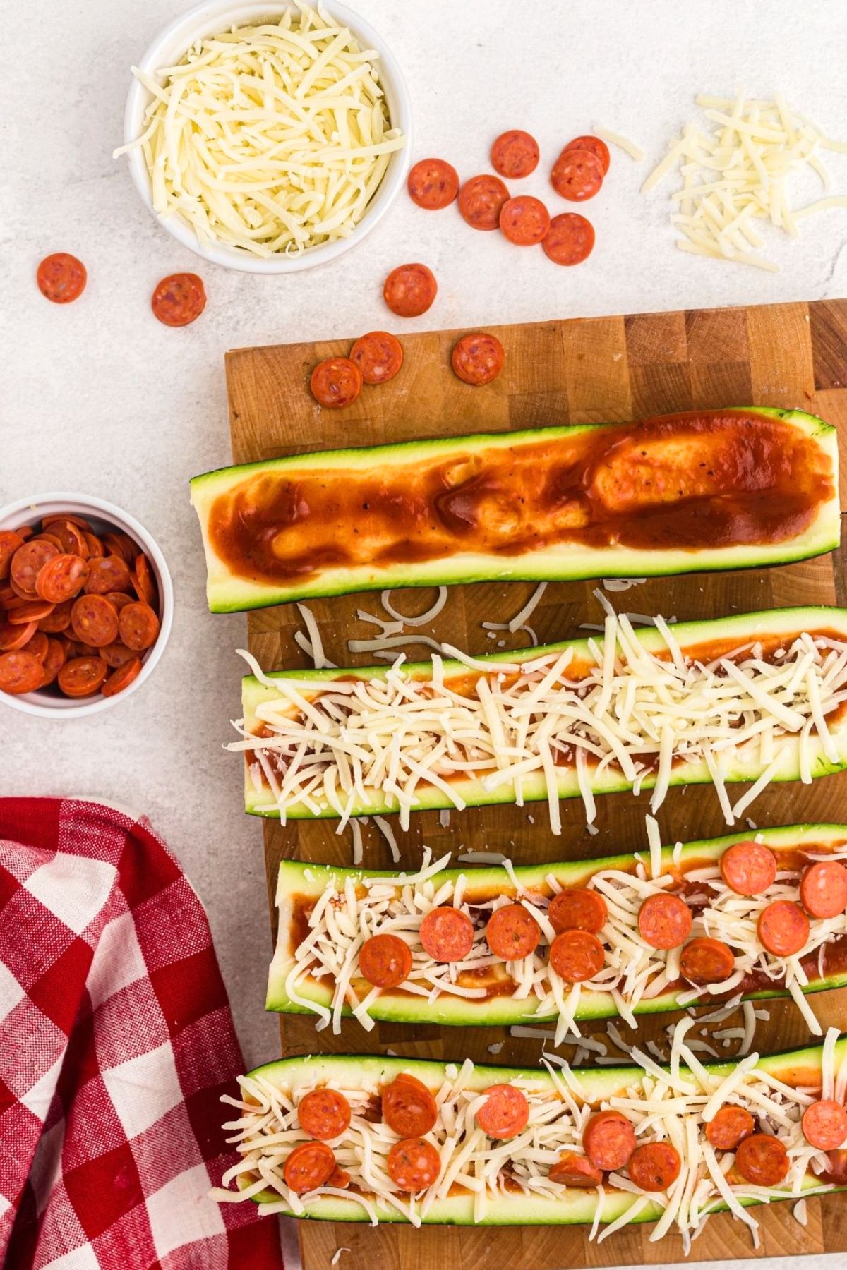 Zucchini cut in half and filled with pizza sauce, cheese, and topped with pepperoni. 