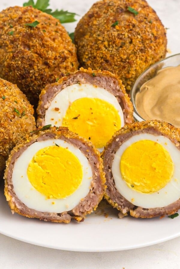 Golden brown crispy coated hard boiled eggs after being cooked in the air fryer