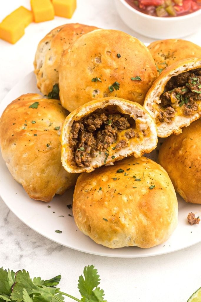 Golden biscuits filled with seasoned hamburger meat and cheddar cheese, served with salsa