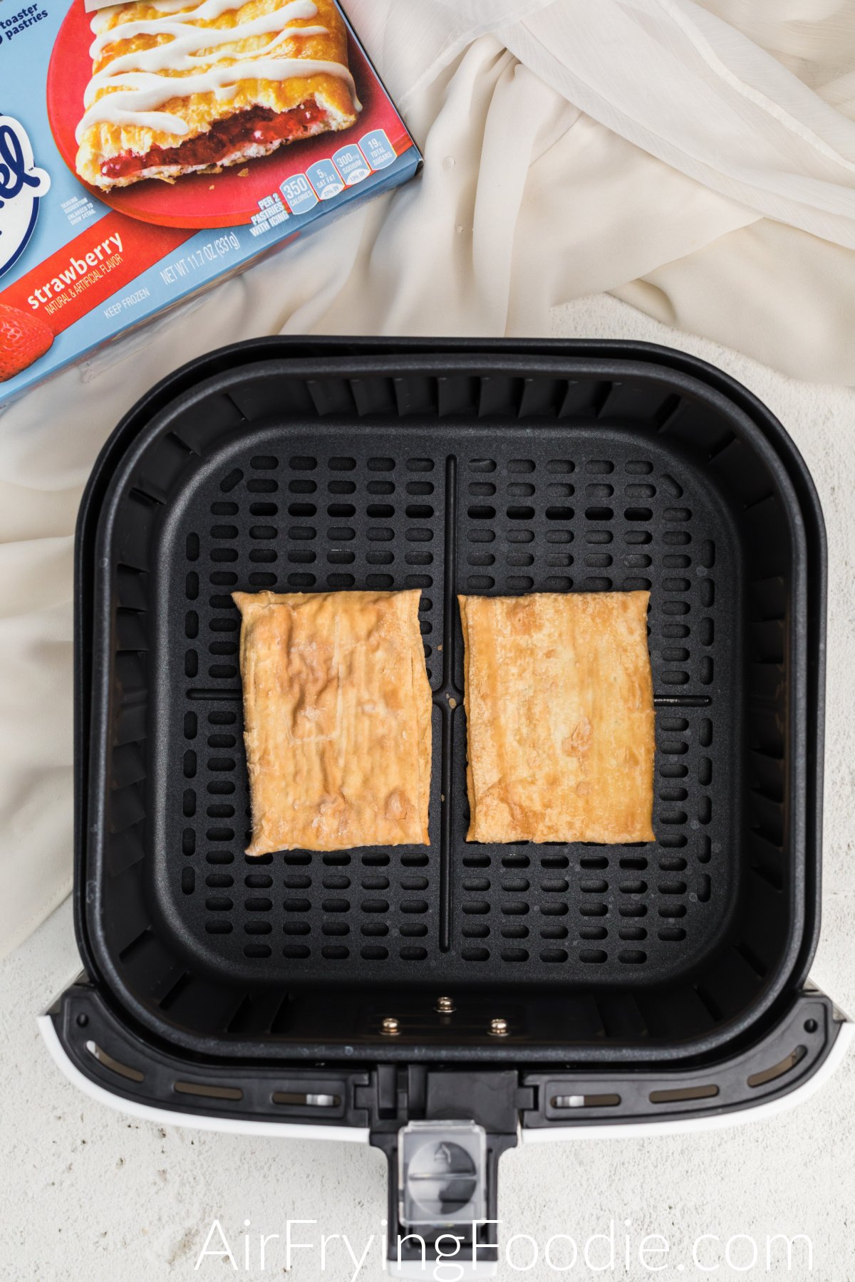 Frozen toaster strudel in air fryer basket.